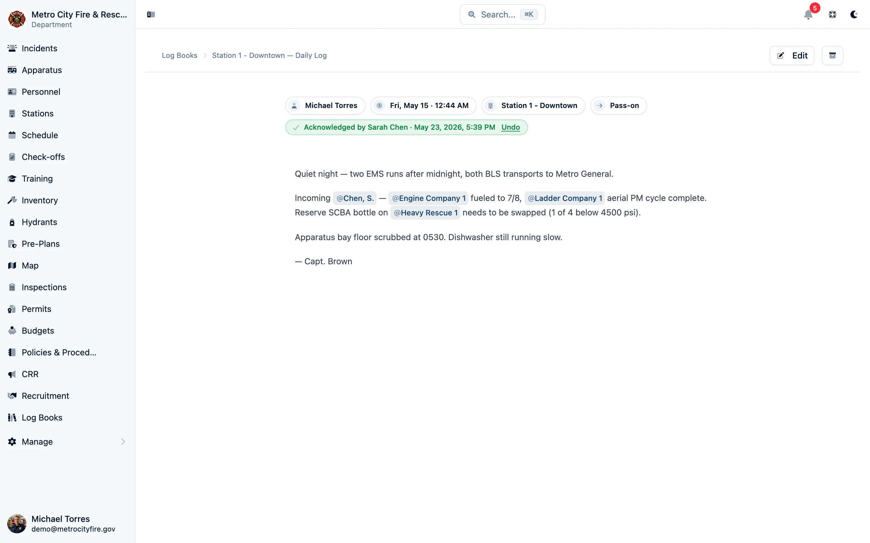 A finished pass-on log entry with rich text and @-mentions, showing the entry type, author, timestamp, and an acknowledgement from the oncoming shift officer